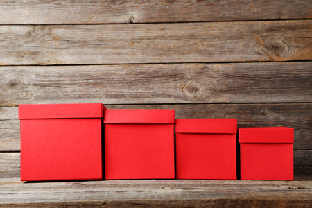 Stacks of red boxes on grey wooden tableの写真素材