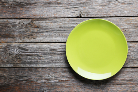 Empty plate on grey wooden tableの写真素材