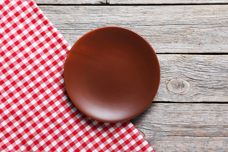 Empty plate with napkin on grey wooden tableの写真素材