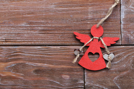 Decorative angel on a brown wooden backgroundの写真素材