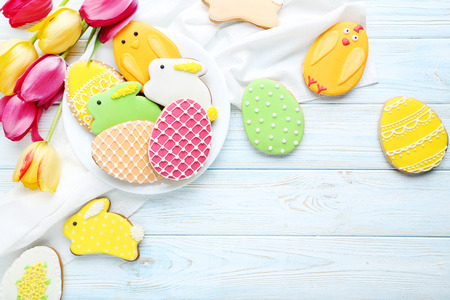 Colorful easter cookies on blue wooden background