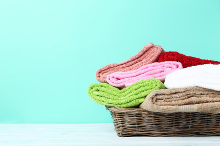 Towels in basket on green backgroundの写真素材