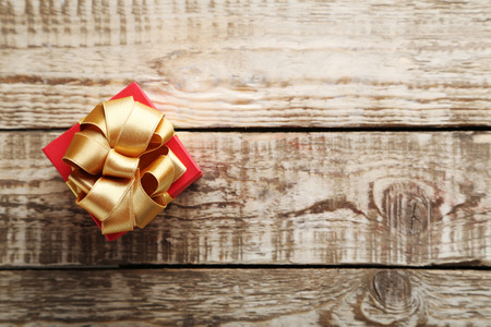 Gift box with ribbon on grey wooden tableの写真素材