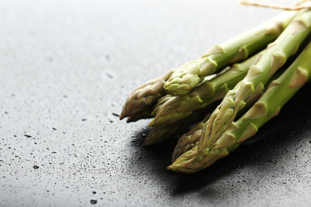 Fresh green asparagus on a black tableの写真素材