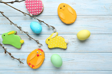 Colorful easter cookies on blue wooden background