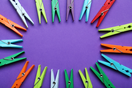 Plastic clothespins on a purple backgroundの写真素材