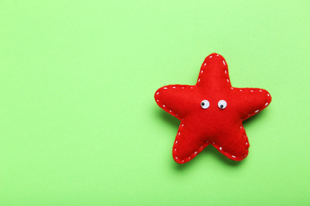 Decoration star with googly eyes on a green backgroundの写真素材