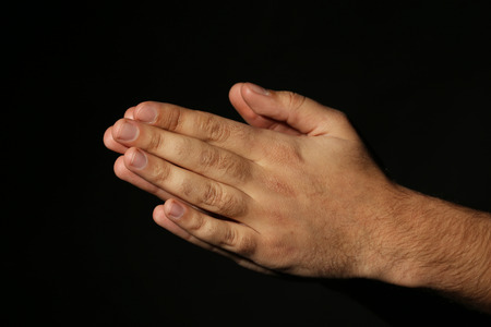 Male hands on a black backgroundの写真素材