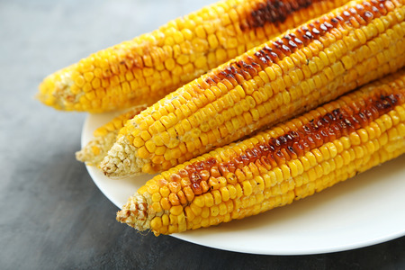 Tasty grilled corn on grey wooden tableの写真素材