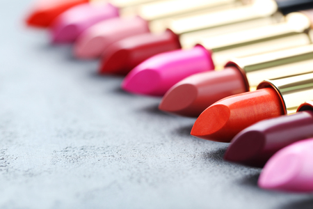 Colorful lipsticks on grey wooden tableの写真素材