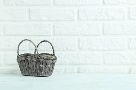 Wicker basket on the brick wall backgroundの写真素材