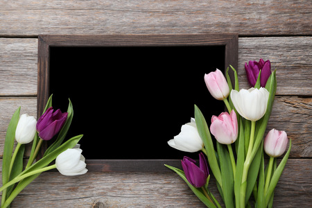 Bouquet of tulips with frame on grey wooden tableの写真素材