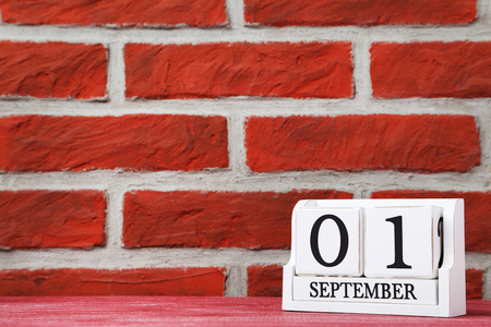 Cube calendar on a brick wall backgroundの写真素材