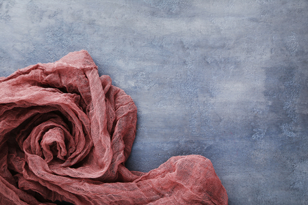 Burgundy gauze fabric on grey wooden tableの写真素材
