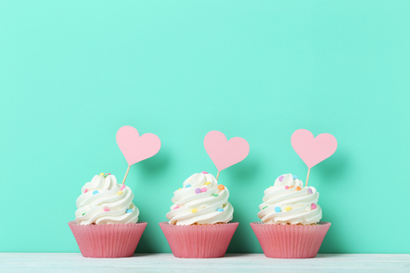 Tasty cupcakes on a green backgroundの写真素材