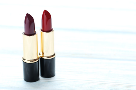 Colorful lipsticks on blue wooden tableの写真素材