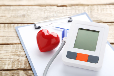 White electric tonometer on brown wooden tableの写真素材