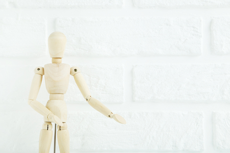 Wooden figure on the brick wall backgroundの写真素材