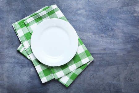Empty plate with napkin on grey wooden tableの写真素材