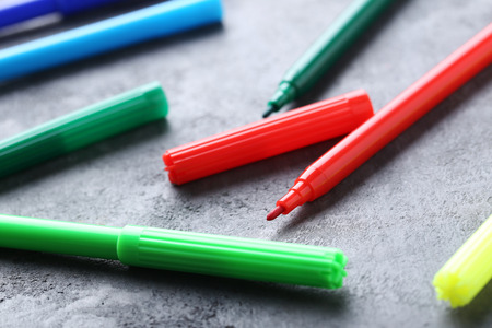 Felt-tip pens on a grey wooden tableの写真素材