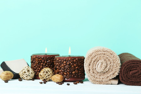 Towels with candles and soap on green backgroundの写真素材
