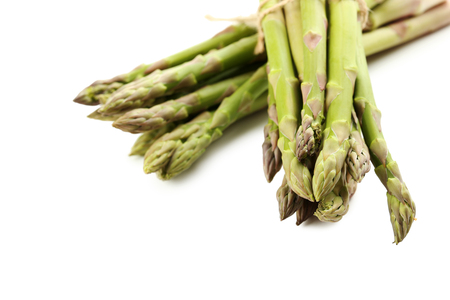 Fresh green asparagus isolated on a whiteの写真素材