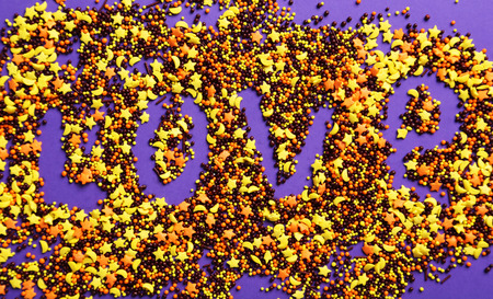 Colorful sprinkle dots and stars on purple backgroundの写真素材