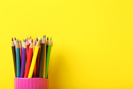 Drawing colourful pencils on yellow backgroundの写真素材