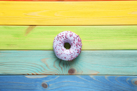 Sweet donut on colorful wooden tableの写真素材
