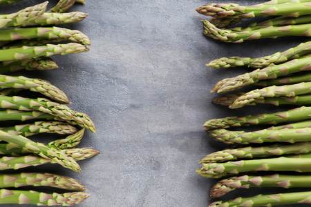 Green asparagus on grey wooden tableの写真素材