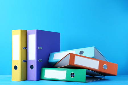 Colorful office folders on blue backgroundの写真素材