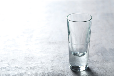 Empty glass on a grey wooden tableの写真素材