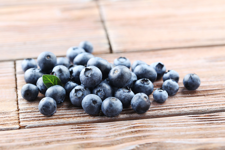 Ripe and tasty blueberries on brown wooden tableの写真素材
