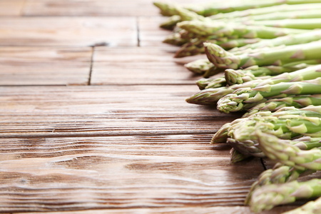 Green asparagus on brown wooden tableの写真素材