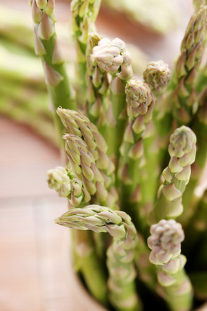 Green asparagus on brown wooden tableの写真素材