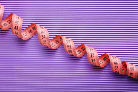 Measure tape on purple backgroundの写真素材