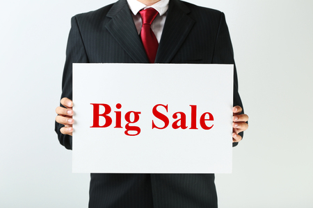 Businessman holding sheet of paper with word Big saleの写真素材