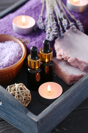 Lavender oil with soap, salt and flowers in blue trayの写真素材