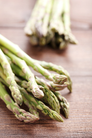 Green asparagus on brown wooden tableの写真素材
