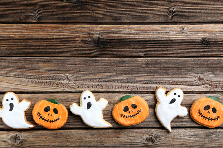 Fresh halloween gingerbread cookies on brown wooden tableの写真素材