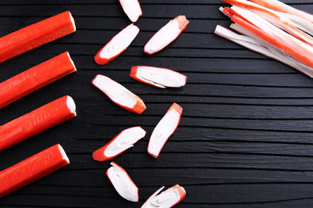 Crab sticks on a black wooden tableの写真素材