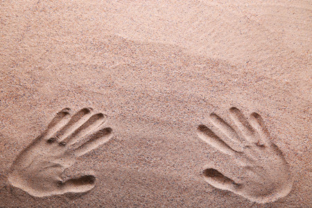 Handprints on the beach sandの写真素材
