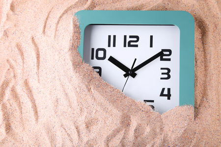 Green clock on the beach sandの写真素材