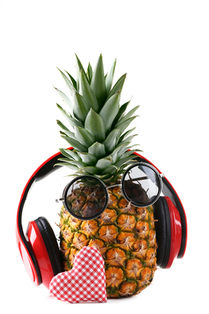 Ripe pineapple with headphones and sunglasses isolated on a white backgroundの写真素材