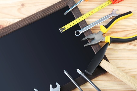Different tools with black frame on wooden tableの写真素材