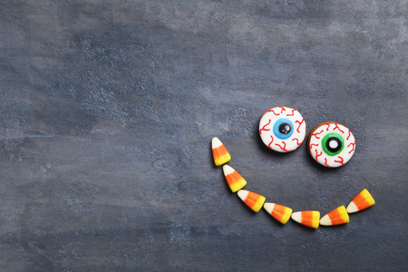 Fresh halloween gingerbread cookies on grey wooden tableの写真素材
