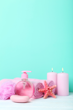 Pink towels with soap and wisp on green backgroundの写真素材