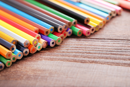 Drawing colourful pencils on brown wooden tableの写真素材