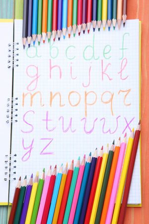 Handwritten alphabet in notebook with colorful pencilsの写真素材