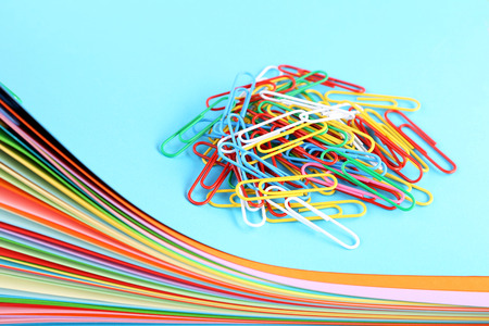 Stack of colored papers with paperclipsの写真素材